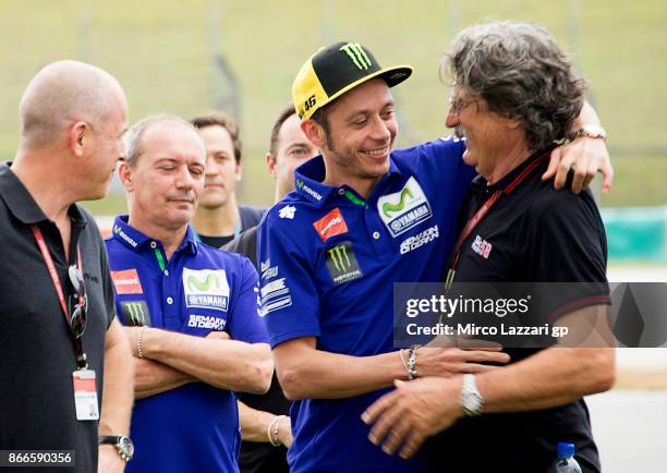 Paolo Simoncelli of Italy hugs Valentino Rossi of Italy and Movistar Yamaha MotoGP during the "Track walk to Turn 11 for SIC " ahead of the MotoGP of...