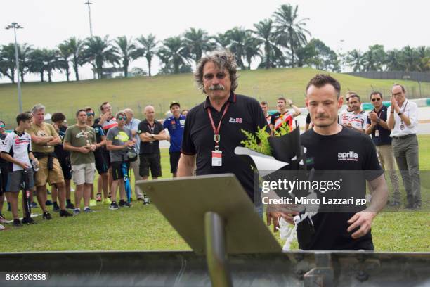 Paolo Simoncelli father of Marco Simoncelli of Italy pray in memory of Marco Simoncelli during the "Track walk to Turn 11 for SIC " ahead of the...