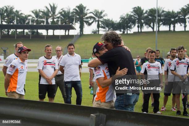 Paolo Simoncelli of Italy hugs Dani Pedrosa of Spain and Repsol Honda Team during the "Track walk to Turn 11 for SIC " ahead of the MotoGP of...