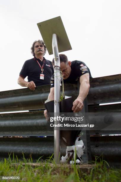 Paolo Simoncelli father of Marco Simoncelli of Italy pray in memory of Marco Simoncelli during the "Track walk to Turn 11 for SIC " ahead of the...
