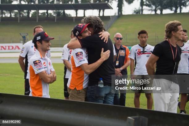 Paolo Simoncelli of Italy hugs Marc Marquez of Spain and Repsol Honda Team during the "Track walk to Turn 11 for SIC " ahead of the MotoGP of...
