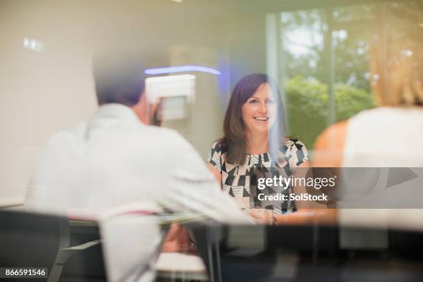 female worker in office meeting - shareholders meeting stock pictures, royalty-free photos & images