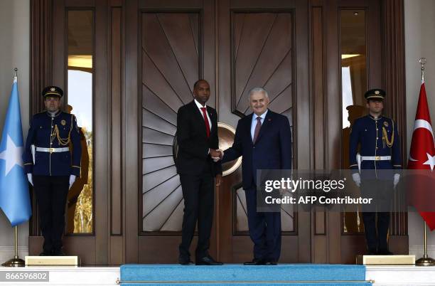Turkish Prime Minister Binali Yildirim shakes hands with Somalian Prime Minister Hassan Ali Khayre upon his arrival at the Cankaya Palace in Ankara,...