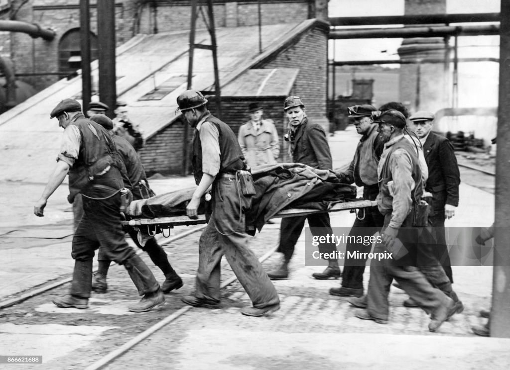 Maypole Colliery Disaster Grim scene, rescuers carry out an injured miner after the Easington ...