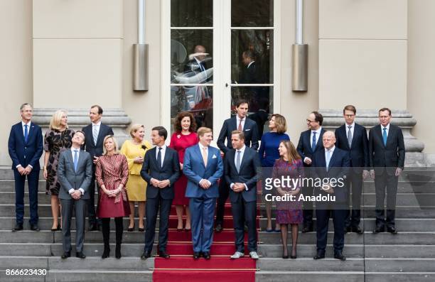 The new ministers and state secretaries of the cabinet Rutte III pose for a group photo with King Willem-Alexander and Prime Minister Mark Rutte at...