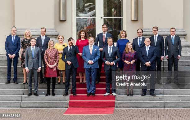 The new ministers and state secretaries of the cabinet Rutte III pose for a group photo with King Willem-Alexander and Prime Minister Mark Rutte at...