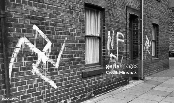 Graffiti Swastikas and National Front signs painted on houses and a public house in Durham Road, Gateshead, Tyne and Wear, England, in the early...