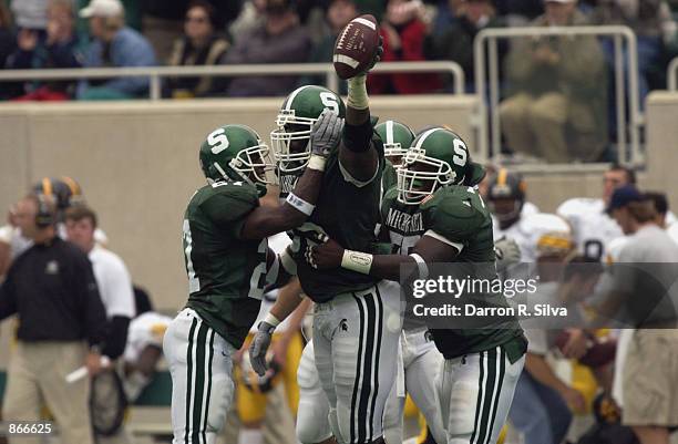 Defensive tackle Josh Shaw of the Michigan State Spartans celebrates with his teammates after one of his two interceptions during the Big Ten...