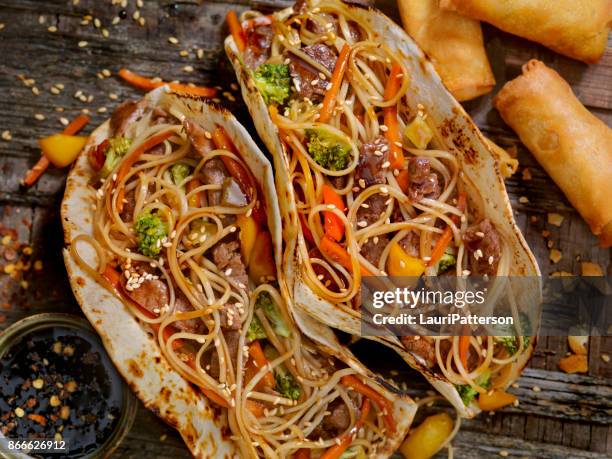 asian/mexican fusion - teriyaki beef and noodle tacos - teriyaki stock pictures, royalty-free photos & images