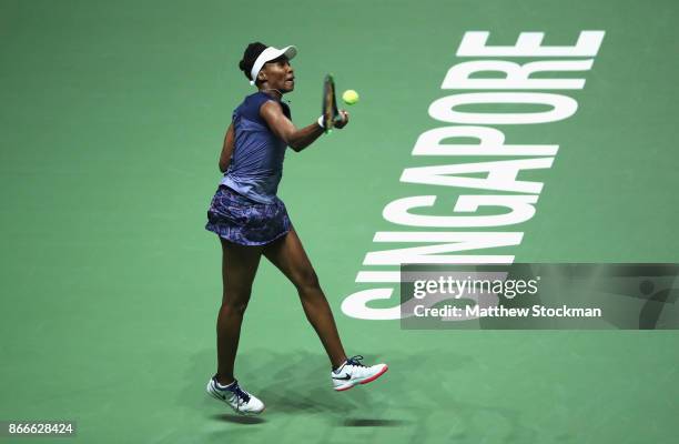 Venus Williams of the United States plays a forehand in her singles match against Garbine Muguruza of Spain during day 5 of the BNP Paribas WTA...