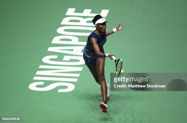 Venus Williams of the United States plays a forehand in her singles match against Garbine Muguruza of Spain during day 5 of the BNP Paribas WTA...