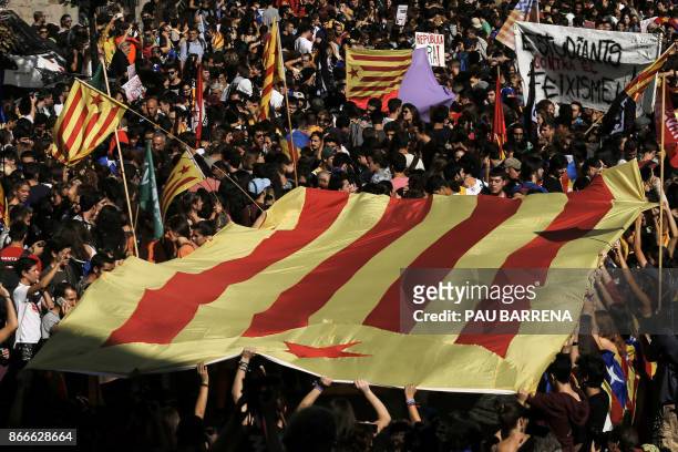 Students carry a Catalan pro-independence 'Estelada' flag during a demonstration in Barcelona on October 26, 2017. Thousands of students rallied in...