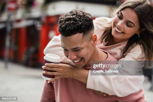 young couple piggyback in dublin - dublin stock pictures, royalty-free photos & images
