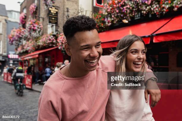 young couple outside public house dublin - ireland stock pictures, royalty-free photos & images