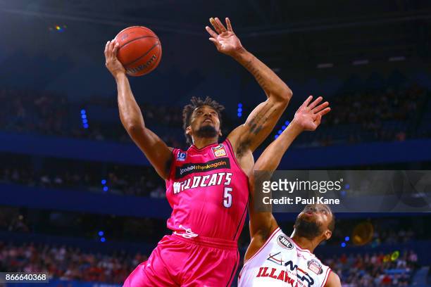 Jean-Pierre Tokoto of the Wildcats lays up against Demitrius Conger of the Hawksduring the round four NBL match between the Perth Wildcats and the...