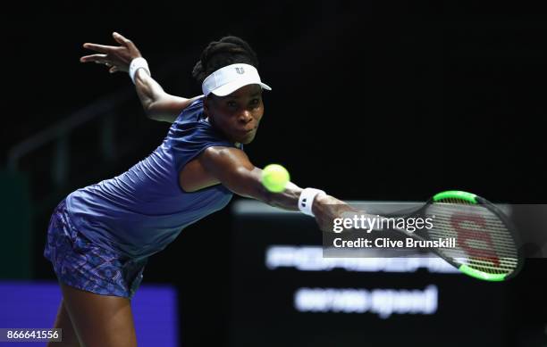 Venus Williams of the United States plays a backhand in her singles match against Garbine Muguruza of Spain during day 5 of the BNP Paribas WTA...