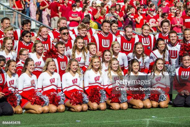 Wisconsin Badger dance team members and Wisconsin Band members pose for a photo durning an college football game between the Maryland Terrapins and...