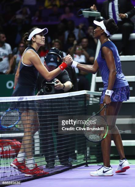 Venus Williams of the United States shakes hands with Garbine Muguruza of Spain after her victory in their singles match during day 5 of the BNP...