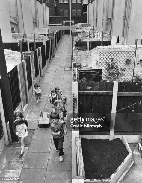 Children playing in alleyways of Liverpool's Flower Streets, Kirkdale, Liverpool, 4th August 1974. .