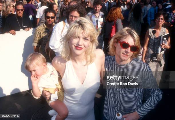 Kurt Cobain of Nirvana poses with his wife Courtney Love of Hole and child Frances Bean Cobain as they attend the 10th Annual MTV Video Music Awards...