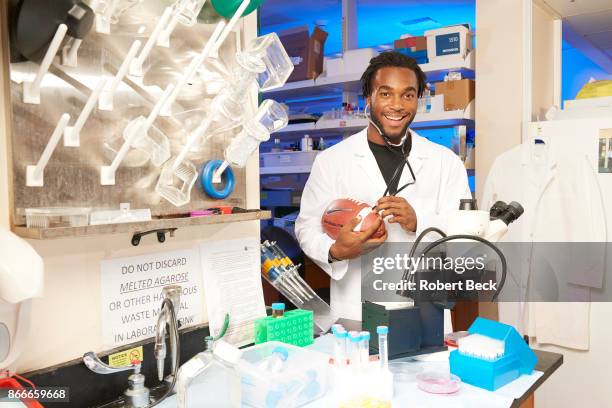 Portrait of Stanford running back Bryce Love posing in lab coat with stethoscope and football during photo shoot at Stanford Universtiy Stem Cell...