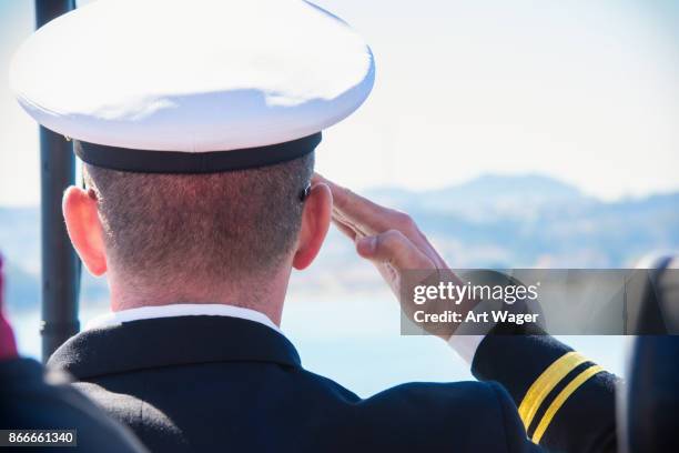 active duty u.s. naval officer saluting - marinha-americana imagens e fotografias de stock
