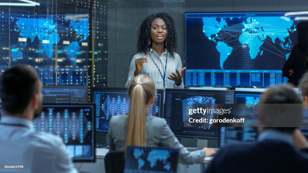 Chief Project Engineer Holds Briefing for a Team of Scientists that are Building Machine Learning System. Displays Show Working Model of Neural Network.