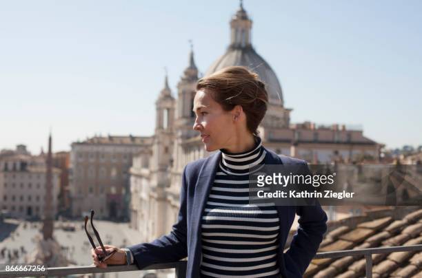 portrait of a woman on a terrace overlooking piazza navona, rome, italy - blue blazer stock pictures, royalty-free photos & images