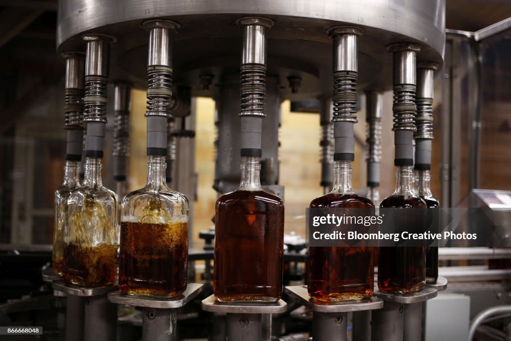 Bottles of single barrel bourbon are filled on the bottling line at a distillery
