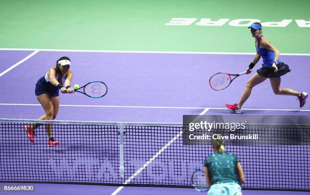 Chan Yung-Jan of Chinese Taipei and Martina Hingis of Switzerland in action in their doubles match against Kveta Peschke of Czech Republic and...