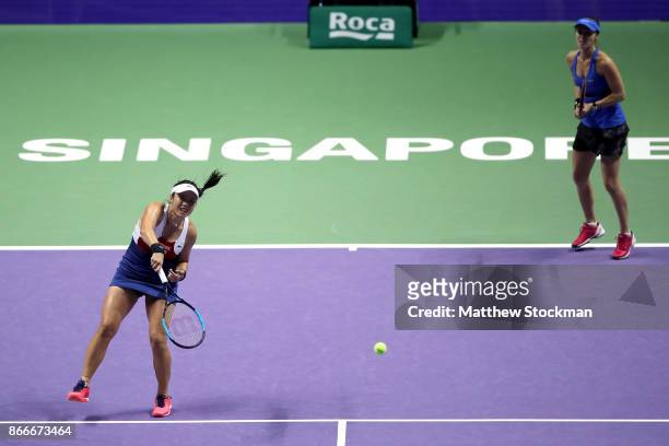 Chan Yung-Jan of Chinese Taipei and Martina Hingis of Switzerland in action in their doubles match against Kveta Peschke of Czech Republic and...
