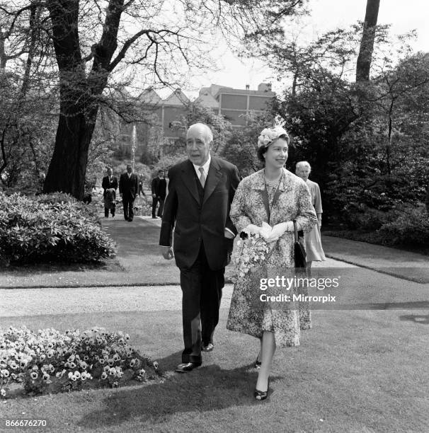 Queen Elizabeth II and Prince Philip, Duke of Edinburgh visit to Denmark. The Queen in a gaily patterned coat and matching dress walks with the...