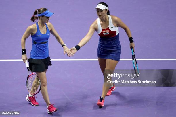 Martina Hingis of Switzerland and Chan Yung-Jan of Chinese Taipei celebrate a point in their doubles match against Kveta Peschke of Czech Republic...