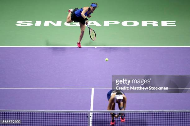 Martina Hingis of Switzerland serves with Chan Yung-Jan of Chinese Taipei in their doubles match against Kveta Peschke of Czech Republic and...
