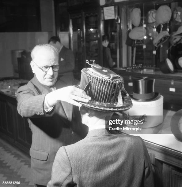 Conformateur, a head-measuring device invented in France by Alli?-Maillard seen here being used to take measurements of a customers head at Scotts...