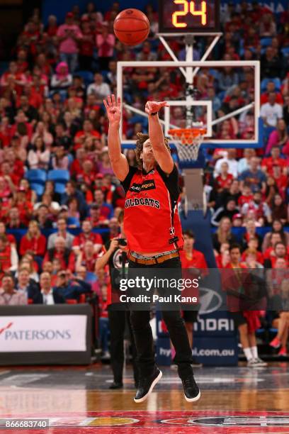 Former AFL player Matt Priddis takes part in a three quarter time half court shoot out during the round four NBL match between the Perth Wildcats and...