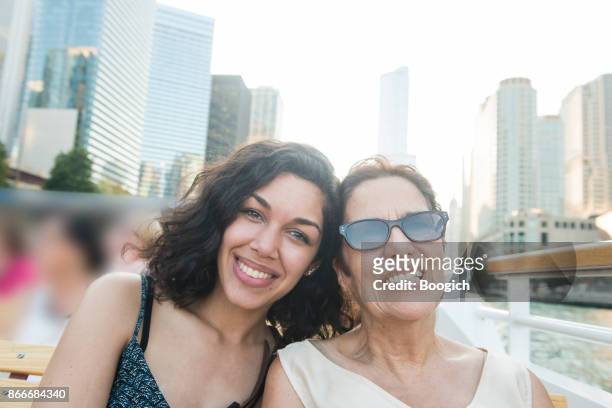 senior hispanic woman and millennial granddaughter on chicago boat tour - hot puerto rican women stock pictures, royalty-free photos & images