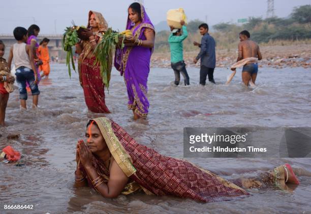 Hindu devotees performing rituals to the God Sun during sunset to mark Chhath Puja festival, on October 26, 2017 in Panchkula, India. Thousands of...