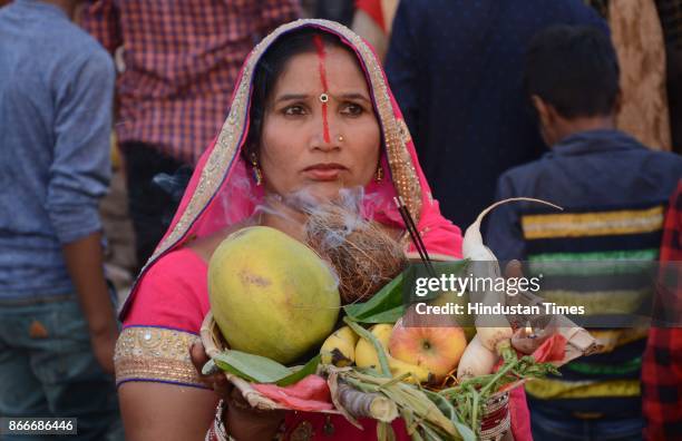 Hindu devotees performing rituals to the God Sun during sunset to mark Chhath Puja festival, on October 26, 2017 in Panchkula, India. Thousands of...