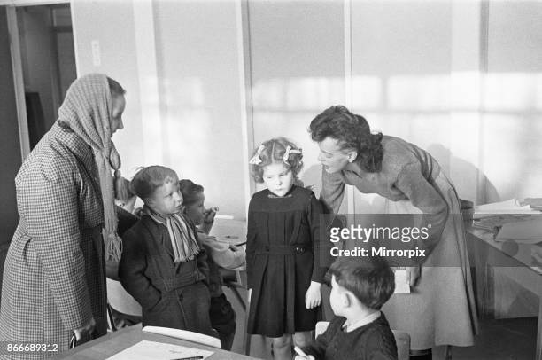 Mother drops off her son at his new school, South Mead School, Southfield, Wimbledon, as the Teacher finds him a classroom mentor, 14th January 1954.