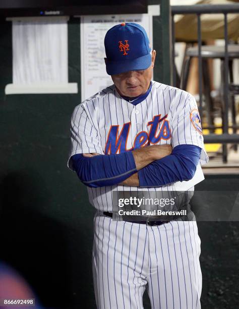 Manager Terry Collins of the New York Mets looks out from the dugout before managing the Mets last home game of the season in an MLB baseball game...