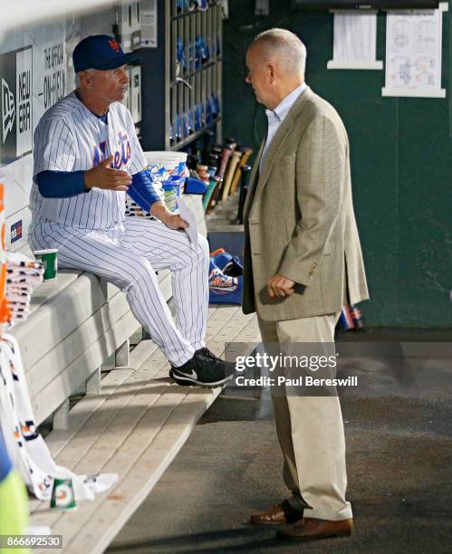 Manager Terry Collins of the New York Mets and General Manager Sandy Alderson have a talk in the dugout before the Mets played their last home game...