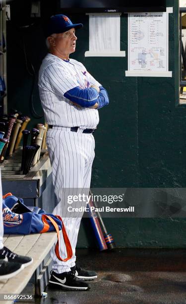 Manager Terry Collins of the New York Mets looks out from the dugout before managing the Mets last home game of the season in an MLB baseball game...