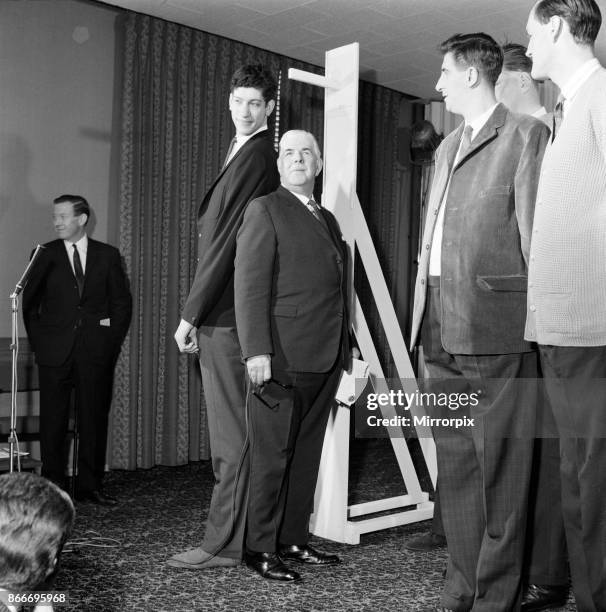 Tallest Man Competition held at the Londoner Hotel, Welbeck Street, London. Winner Mr Christopher Greener standing back to back with Ex-Regimental...