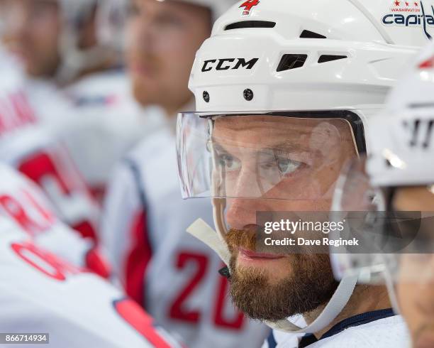 Taylor Chorney of the Washington Capitals watches the action from the bench against the Detroit Red Wings during an NHL game at Little Caesars Arena...