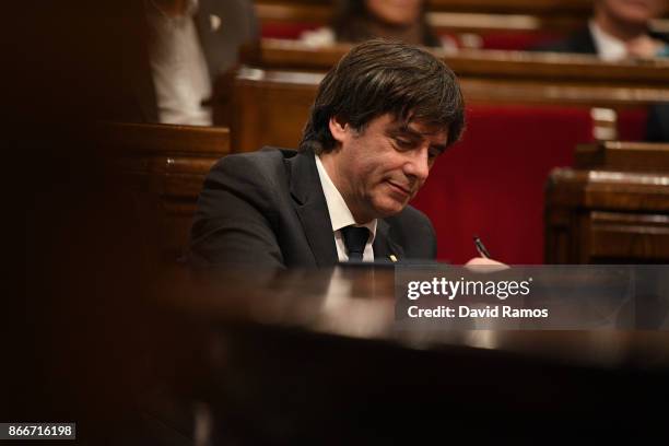 Catalan President Carles Puigdemont writes notes during a meeting at the Catalan Government building Generalitat de Catalunya on October 26, 2017 in...