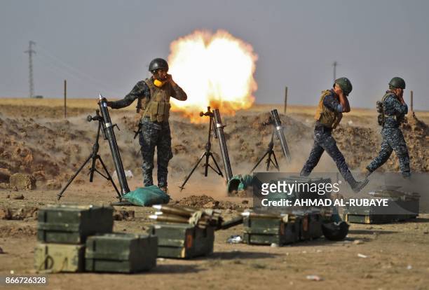 Members of the Iraqi forces fire mortars against Kurdish Peshmerga positions near the area of Faysh Khabur, located on the Turkish and Syrian borders...