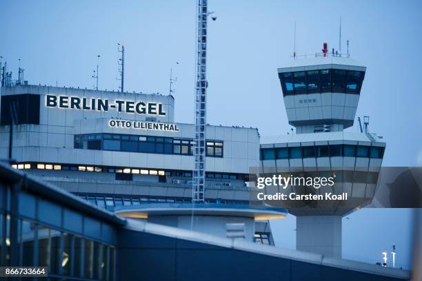The letters of the name of the airport "Berlin-Tegel Otto Lilienthal" are illuminated beside the control tower at Tegel Airport on October 26, 2017...