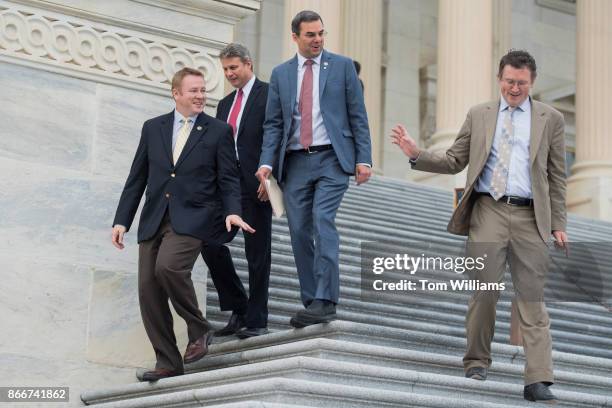 From left, Reps. Warren Davidson, R-Ohio, Bill Huizenga, R-Mich., Justin Amash, R-Mich., and Thomas Massie, R-Ky., leave the Capitol after the House...