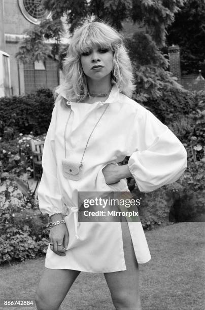 Model wearing 1977 clothing, Sunday Mirror fashion feature, pictured in garden, 2nd August 1977, picture shows model Jo Wood.